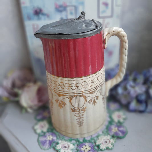 Decorative red and beige container with floral patterns on a blurred background